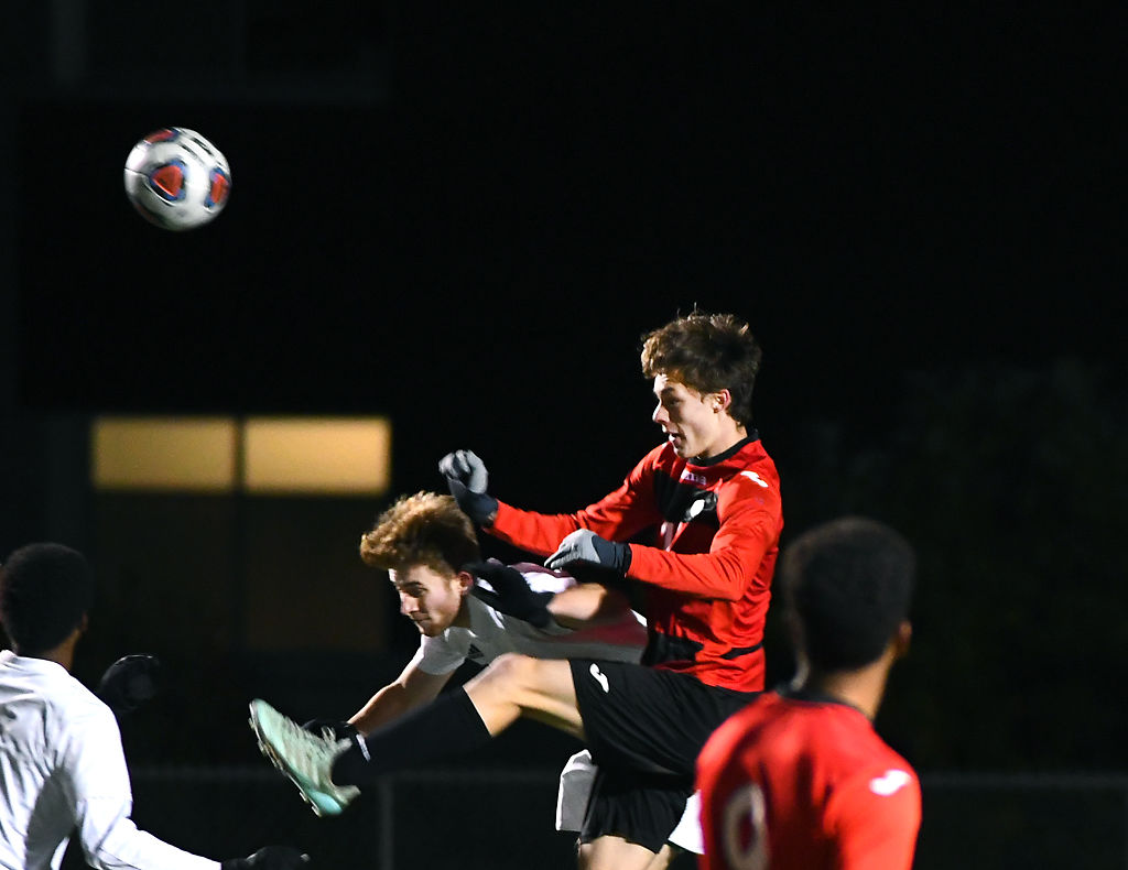 From left, Rock Bridge midfielder Preston Fancher and Jefferson City midfielder Bowen West jump for the ball in a game against the Jefferson City Jays Thursday